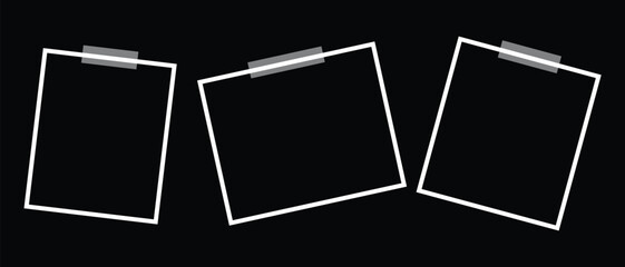 Three blank photo frames taped to a, ideal for creating a minimalist display or showcasing images with contrast