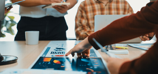 A dynamic office scene showcasing professionals engaged in a collaborative meeting, analyzing data charts and discussing strategies to enhance productivity and insights. SACTR