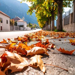 Autumn leaves blanket a town street lined with trees.  A sunny day