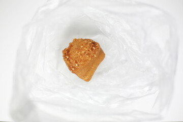 Indonesian sweet fried bread with sesame seeds in transparent plastic bag