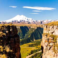 Mountain vista from a craggy cliff.  Vast valley, snow-capped peak, vibrant colors