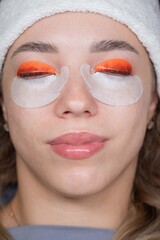 Caucasian woman undergoing eyelash lamination procedure. top view. 