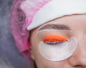 Caucasian woman undergoing eyelash lamination procedure. top view. 