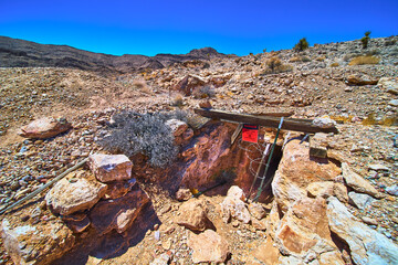 Abandoned Mine Entrance Rocky Desert Terrain and Warning Sign in Nevada