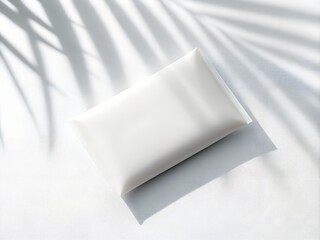 White Rectangular Pouch with Palm Leaf Shadows on White Surface image photo