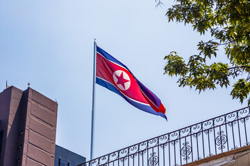 North Korean flag waving on the roof of a building at the North Korean embassy in Mexico City  © Alex Borderline