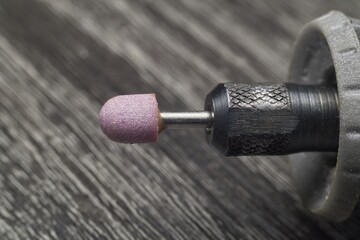 Close-Up Of Purple Abrasive Drill Bit Mounted On Rotary Tool For Nails And Metalwork