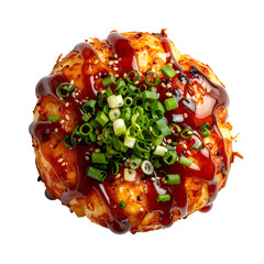 A spherical, savory food item, drizzled with sauce and topped with scallions & sesame seeds