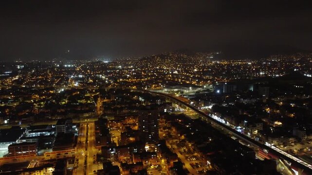 Aerial view of the illuminated cityscape of lima, peru, with glowing streets and buildings