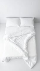 Top view of a clean, minimalist white bed with two pillows and a rumpled duvet, suggesting comfort and tranquility