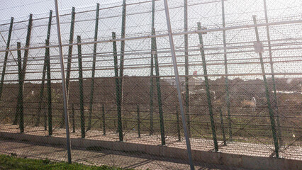Obraz premium The Melilla fence is a physical barrier located on the border of the Spanish city of Melilla with Morocco, in North Africa and in Spanish territory. Its purpose is to hinder or prevent the entry 