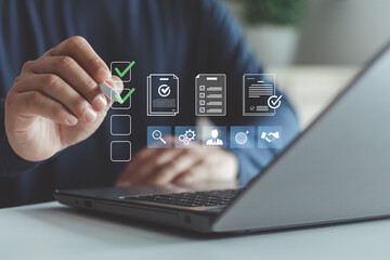 Businessman using laptop with virtual checklist and document icons, task management, digital...