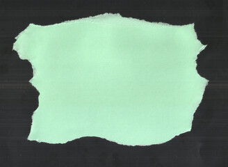 Torn Light Green Paper with Jagged White Edges on Dark Background and Organic Texture