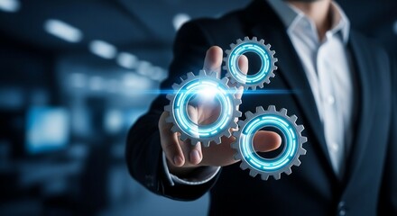 Professional businessman's hand engaging with glowing blue digital gears, symbolizing innovation, strategy, and system control in a modern business environment.