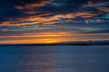 Dramatic Icelandic sunset over the Atlantic Ocean with colorful clouds