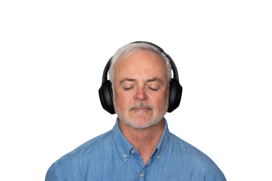 Close up portrait of handsome Mature man listening to music with headphones against a transparent background.