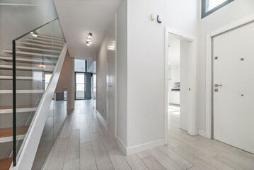 Entrance area with underfloor heating, wood paneling on the walls, and a smart storage system with drawers