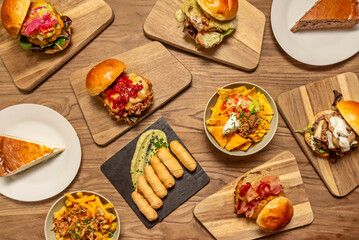 Premium burger with venison, melted Camembert cheese, sliced ​​tomatoes, and romaine lettuce between artisan brioche buns