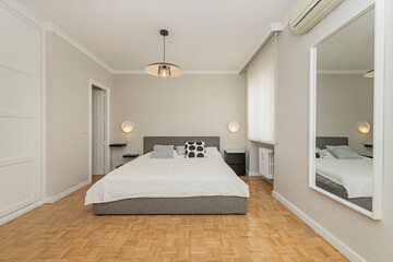 Bridal suite with a 200 cm wide bed with a solid wood headboard, linen bedspread, and decorative...