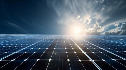 Solar panels shine under a bright sun and blue sky with clouds, capturing renewable energy at a solar farm