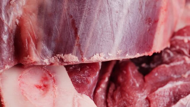 Fresh beef ossobuco steak with salt, spices and herbs on textured background, bones. 