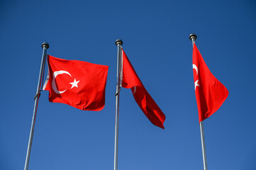 The flags of the Republic of Turkey on the flagpole. National symbol of Turkey. Turkish flags. Flag of Turkye. 
