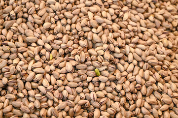 Pistachios for sale at the market. Heap of pistachios, close-up.