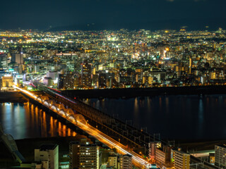 Osaka view from above. Regions Japan. Night view Japanese city with river. Osaka province. Evening cityscape Honshu island. Yodo river in Osaka. Lights of night metropolis. Japan from bird eye view