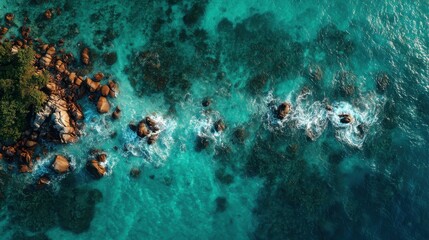 An aerial view of ocean waves crashing over rocks