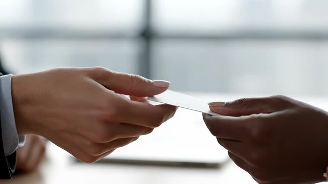 Business card exchange between two professionals during a meeting or negotiation