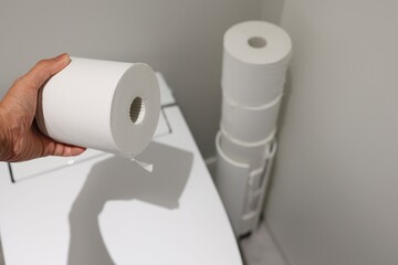 トイレの隅に積まれたトイレットペーパーと収納ケース。