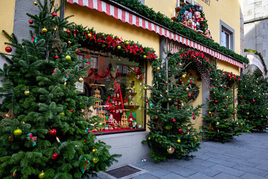 Christmas decoration shop in Rothenburg ob der Tauber, Bavaria, Germany. Beautiful Christmas trees and festive ornaments displayed outside the store, creating a magical holiday atmosphere 