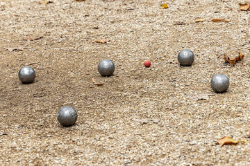 France, Paris. Jardin du Luxembourg (Luxembourg Garden), metal petanque boules surrounding the target ball called the cochonnet or jack.