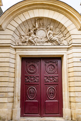 France, Paris. Doorway with Medusa (gorgon) head carvings.
