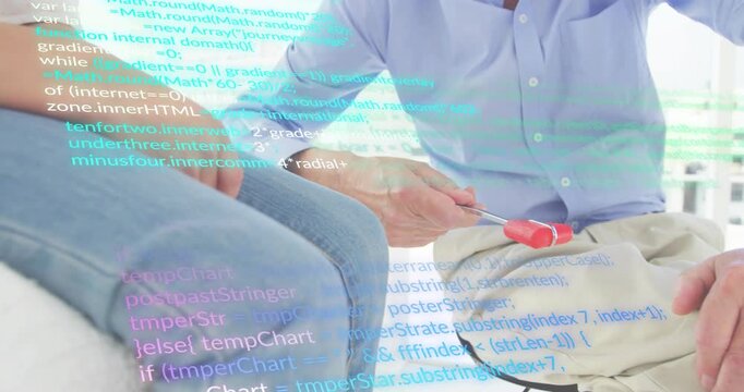 Father picking up screwdriver, showing use to daughter and reviewing assembly instructions in DIY