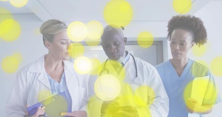 Medical team viewing animated charts, doctor switching from smartphone to tablet, discussing dosage - Powered by Adobe