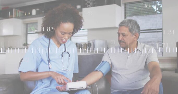 Nurse applying BP cuff on patient and powering medical monitor showing waveform while measuring BP
