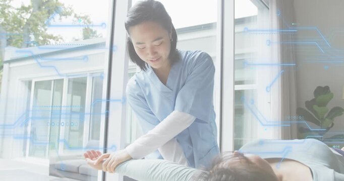 Therapist placing hands under patient arm and lifting it for shoulder therapy with graphics overlay