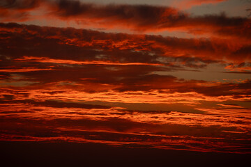 dramatic red sunset sky with luminous clouds