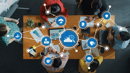 Collaborative Business Management Meeting with Icon Representations of Data Analytics and Strategy on a Table with Diverse Team Members. Amity