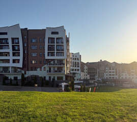 New apartments stand beside the river, featuring modern architecture and green grassy areas