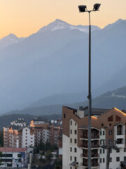 Sunset bathes city buildings in warm light, showcasing their architecture and beauty