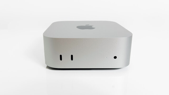 Apple Mac Mini M4 computer on a white desk. Front view.