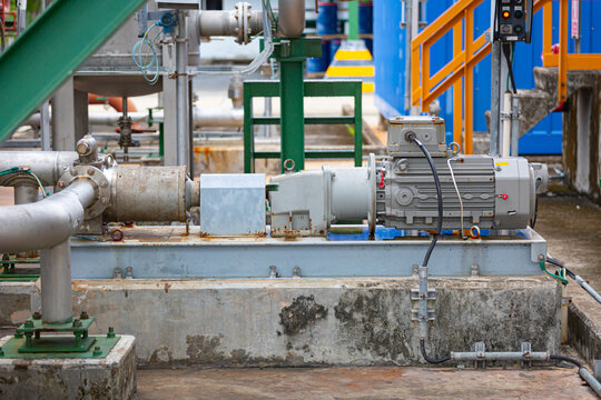 Screw pump with induction motor connected to chemical pipeline in the process area of a chemical factory,