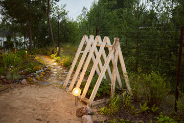 A Magical and Enchanting Garden Pathway Surrounded by a Charming Wooden Archway to Enjoy