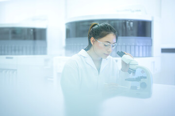 A pathologist performs real-time annotation, looking at a tissue biopsy under the microscope while using a stylus and tablet to digitally circle and document abnormal cells for her report.