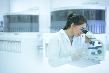 A pathologist performs real-time annotation, looking at a tissue biopsy under the microscope while using a stylus and tablet to digitally circle and document abnormal cells for her report.
