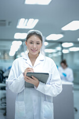 A Clinical Research Coordinator uses a tablet for electronic data capture, managing patient eCRFs and ensuring data integrity for a clinical trial in a modern research facility.