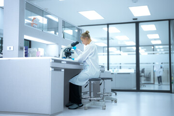 In a future 'open science' lab, researchers instantly upload microscopic findings to a global collaborative platform, receiving real-time peer feedback from a decentralized network of scientists.