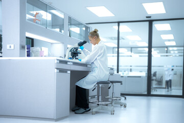 In a future 'open science' lab, researchers instantly upload microscopic findings to a global collaborative platform, receiving real-time peer feedback from a decentralized network of scientists.